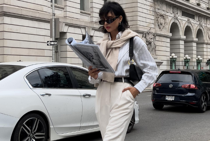 This outfit perfectly embodies old money style with tailored trousers, a classic button-down shirt, and a draped sweater.